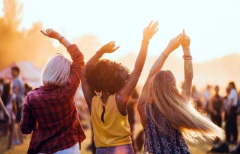 Multiethnic friends having fun at summer festival